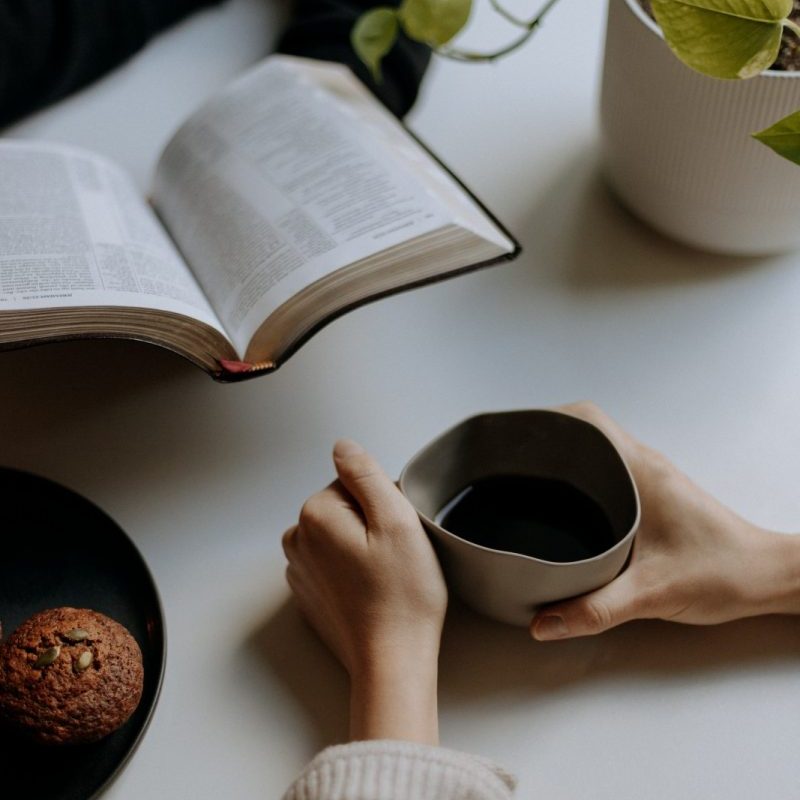 person holding black ceramic mug with coffee